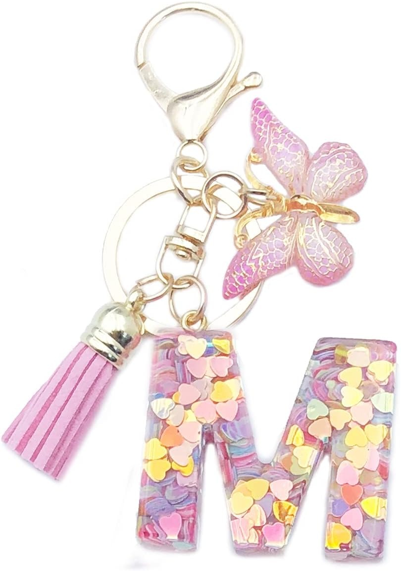 Keychain with colorful letter 'M' charm, pink tassel, and butterfly